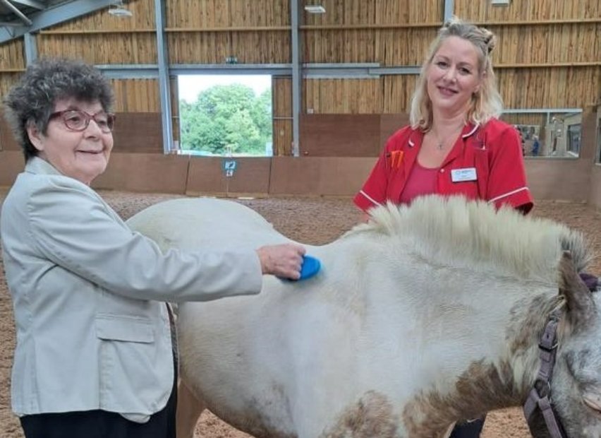 Haughgate House's resident and carer interactiong with pony